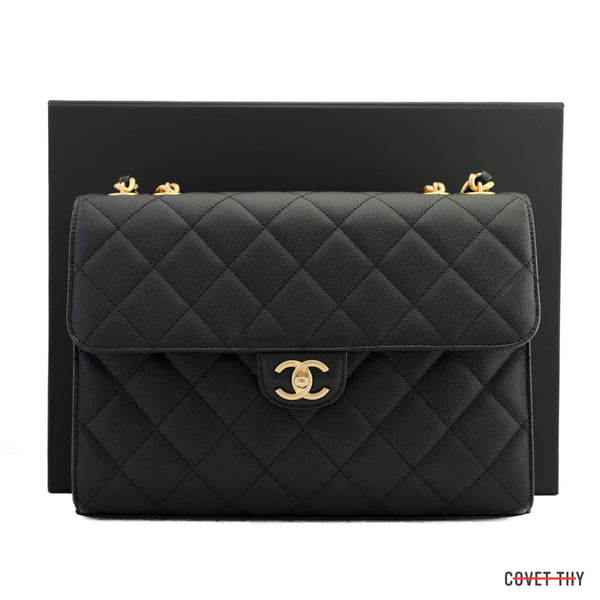This exquisite vintage piece boasts a black diamond quilted caviar leather exterior which harmonizes with its brushed gold hardware. It includes a Chanel box with tissue paper, a pamphlet, ribbon, and an original dust bag, adding to its timeless allure.